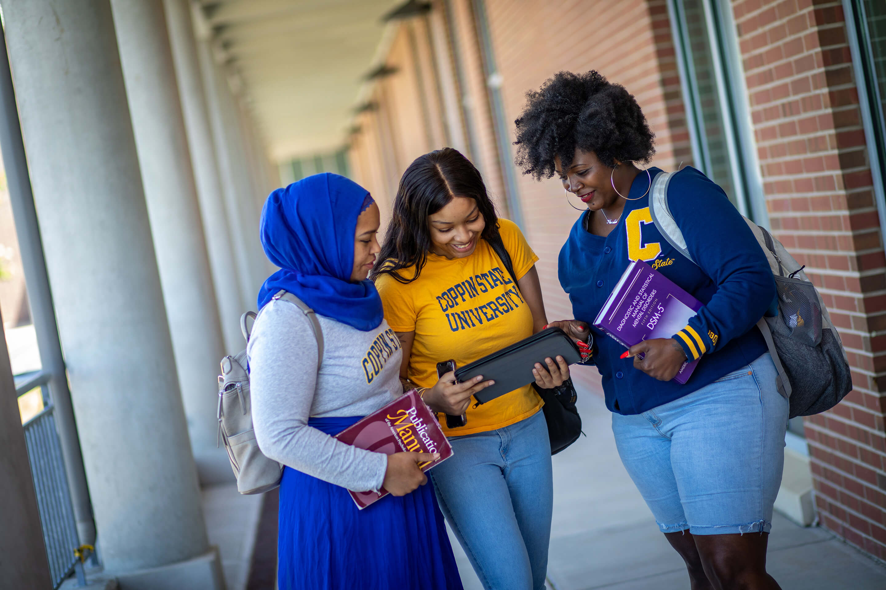 three students talking outside