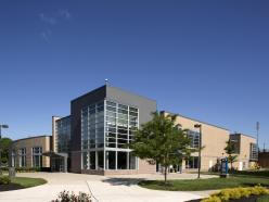 Grey and tan brick and windows of the Talon Center on a sunny day on the Coppin State University campus.