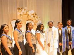 Posed picture of 9 Coppin students dressed formally while wearing their royal court regalia