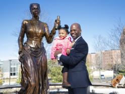 President Jenkins holding a young child