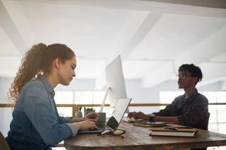 Two students on their laptops 