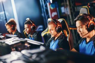 a team sitting down at their computers at a gaming tournament